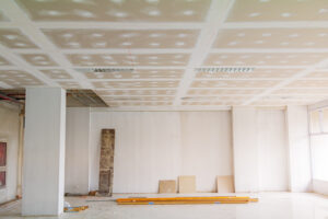 drywall repair service near – newly installed drywall with tape, mud, and plastering finished, ready for paint