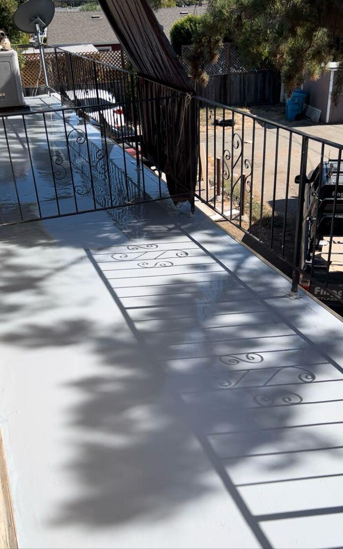 Completed balcony restoration with new railing and waterproof flooring by balcony contractor repair San Jose.