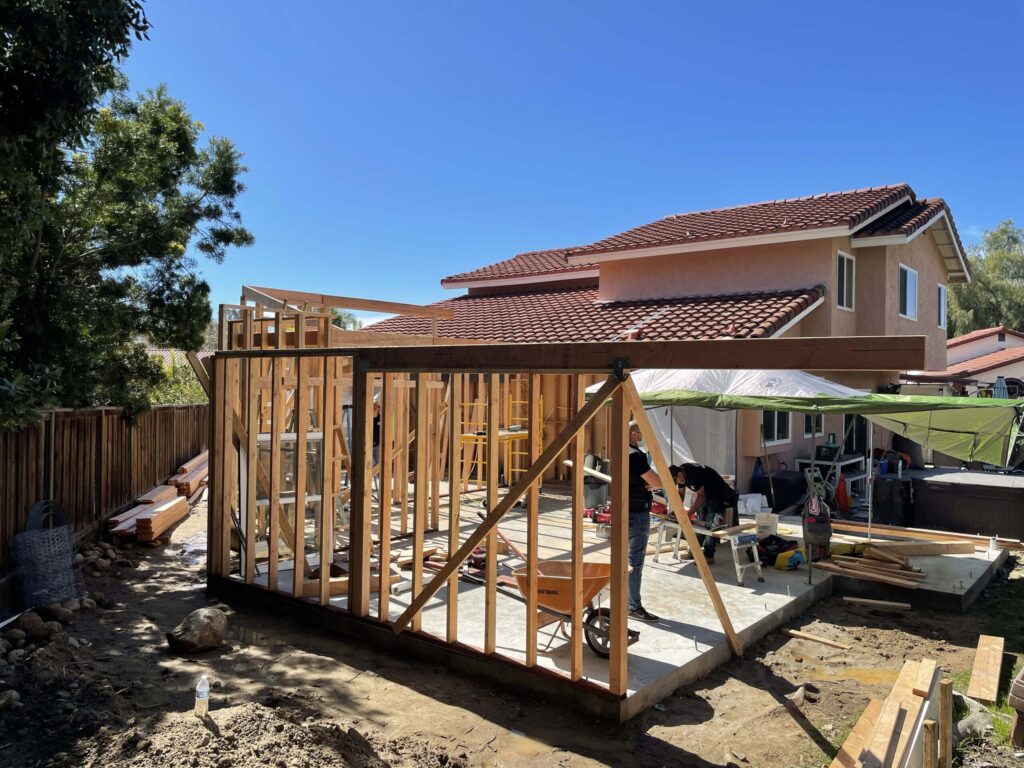 Room addition in progress with wood framing and construction tools on-site—built by licensed framing contractors near San Jose.